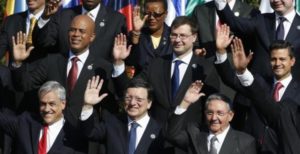 (Top L to R) Haiti's President Michel Martelly, Latvia's Prime Minister Valdis Dombrovskis, Mexico's President Enrique Pena Nieto, (bottom L to R) Chile's President Sebastian Pinera, the head of the European Commission Jose Manuel Barroso and Cuba's President Raul Castro wave to the media during the group picture during the summit of the Community of Latin American, Caribbean States and European Union (CELAC-UE) in Santiago in this January 26, 2013. Photo Source: REUTERS/ Andres Stapff.